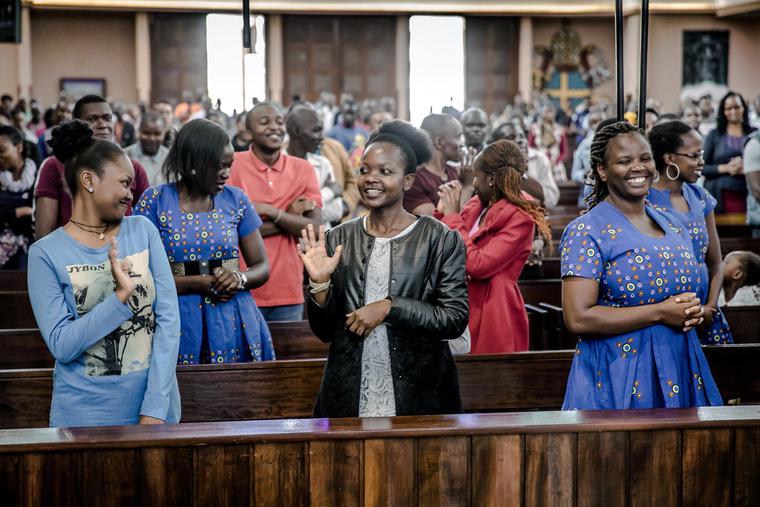 Catholics exchange the sign of peace without shaking hands during a Sunday Mass at Holy Family Minor Basilica in Nairobi, Kenya, on March 22, 2020. Catholics exchange the sign of peace without shaking hands during a Sunday Mass at Holy Family Minor Basilica in Nairobi, Kenya, on March 22, 2020.