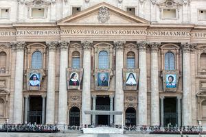 Banners with the official images of (L to R) Sister Irmã Dulce Pontes, Mother Giuseppina Vannini, John Henry Newman, Mother Mariam Thresia and Marguerite Bays hang on the facade of St. Peter's Basilica Oct. 10, 2019, three days before their canonization. Banners with the official images of (L to R) Sister Irmã Dulce Pontes, Mother Giuseppina Vannini, John Henry Newman, Mother Mariam Thresia and Marguerite Bays hang on the facade of St. Peter's Basilica Oct. 10, 2019, three days before their canonization.
