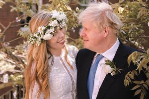 Prime Minister Boris Johnson poses with his wife Carrie Johnson in the garden of 10 Downing Street following their wedding at Westminster Cathedral, May 29, 2021 in London, England. Prime Minister Boris Johnson poses with his wife Carrie Johnson in the garden of 10 Downing Street following their wedding at Westminster Cathedral, May 29, 2021 in London, England.