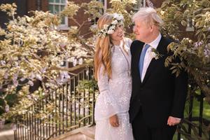 In this handout image released by 10 Downing Street, Prime Minister Boris Johnson poses with his wife Carrie Johnson in the garden of 10 Downing Street following their wedding at Westminster Cathedral, May 29, 2021 in London, England. In this handout image released by 10 Downing Street, Prime Minister Boris Johnson poses with his wife Carrie Johnson in the garden of 10 Downing Street following their wedding at Westminster Cathedral, May 29, 2021 in London, England.