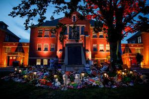 A makeshift memorial to honour the 215 children whose remains have been discovered buried near the facility is seen as orange light drapes the facade of the former Kamloops Indian Residential School in Kamloops, British Columbia, Canada, on June 2, 2021. A makeshift memorial to honour the 215 children whose remains have been discovered buried near the facility is seen as orange light drapes the facade of the former Kamloops Indian Residential School in Kamloops, British Columbia, Canada, on June 2, 2021.