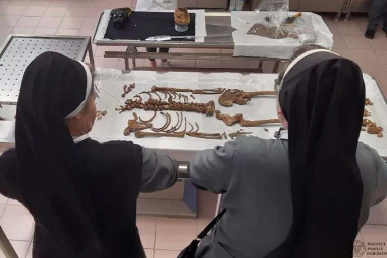 Religious sisters view remains discovered at a site in Gdańsk, northern Poland. Religious sisters view remains discovered at a site in Gdańsk, northern Poland.