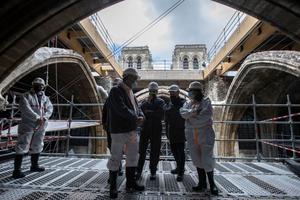 French President Emmanuel Macron (3rd L), the architecte in charge of the restoration Philippe Villeneuve (2nd R), Paris' mayor Anne Hidalgo (R) and Paris' Archbishop Michel Aupetit (2nd L), tour the scaffolding under the vault of Notre-Dame de Paris Cathedral during a visit marking two years since the blaze that made the spire collapsed and destroyed much of the roof, in Paris on April 15, 2021. French President Emmanuel Macron (3rd L), the architecte in charge of the restoration Philippe Villeneuve (2nd R), Paris' mayor Anne Hidalgo (R) and Paris' Archbishop Michel Aupetit (2nd L), tour the scaffolding under the vault of Notre-Dame de Paris Cathedral during a visit marking two years since the blaze that made the spire collapsed and destroyed much of the roof, in Paris on April 15, 2021.