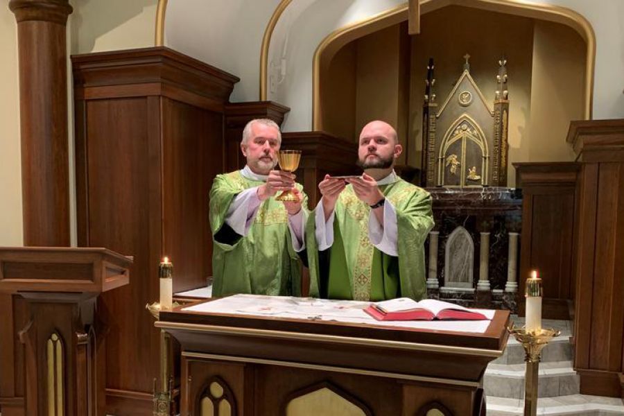 Father Eric Seitz says Mass, with his father, Deacon Ben Seitz, assisting as deacon. Father Eric Seitz says Mass, with his father, Deacon Ben Seitz, assisting as deacon.