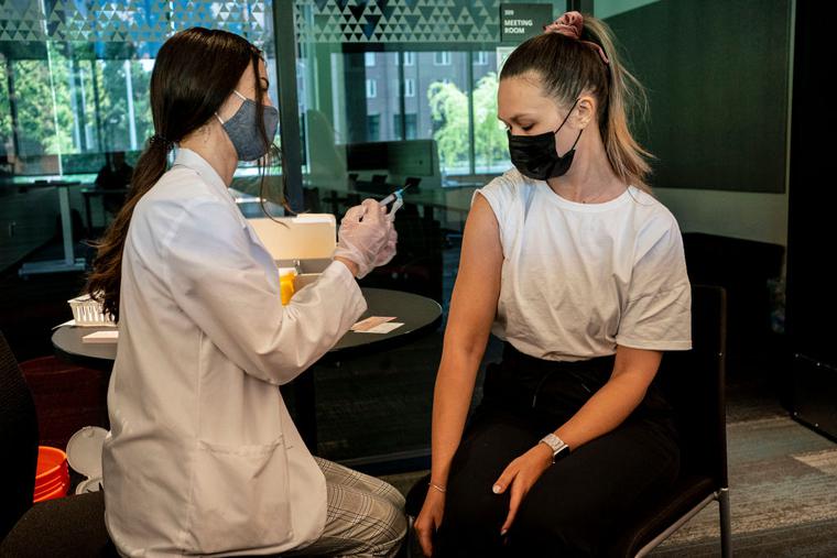 A student receives a COVID-19 vaccine at a vaccination clinic on the University of Washington campus on May 18 in Seattle. A student receives a COVID-19 vaccine at a vaccination clinic on the University of Washington campus on May 18 in Seattle.