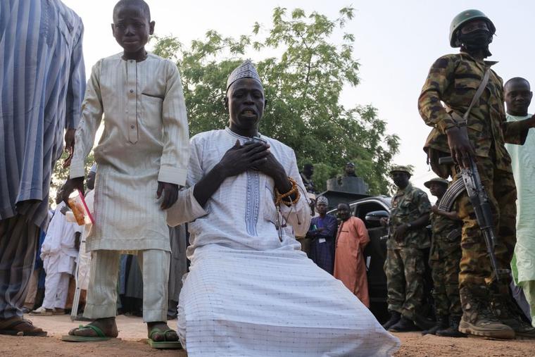 A man reacts as he reunites with his son who was among those who were kidnapped upon their release in Katsina, on December 18, 2020. - Exhausted and dishevelled, several hundred Nigerian schoolboys seized in a mass abduction claimed by Boko Haram experienced their first full day of freedom on December 18, 2020 after a nearly week-long ordeal. A man reacts as he reunites with his son who was among those who were kidnapped upon their release in Katsina, on December 18, 2020. - Exhausted and dishevelled, several hundred Nigerian schoolboys seized in a mass abduction claimed by Boko Haram experienced their first full day of freedom on December 18, 2020 after a nearly week-long ordeal.