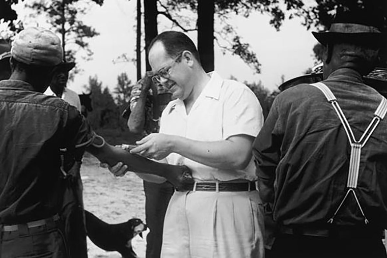 A researcher draws blood from participants in the Tuskegee experiment. A researcher draws blood from participants in the Tuskegee experiment.