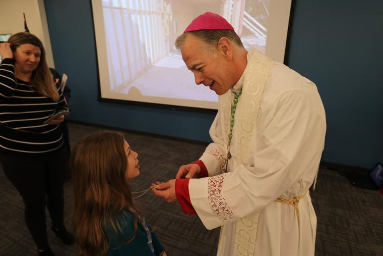 rchbishop Alexander K. Sample blesses a rosary for a girl Queen of Peace Parish in Salem, Oregon in 2020. rchbishop Alexander K. Sample blesses a rosary for a girl Queen of Peace Parish in Salem, Oregon in 2020.