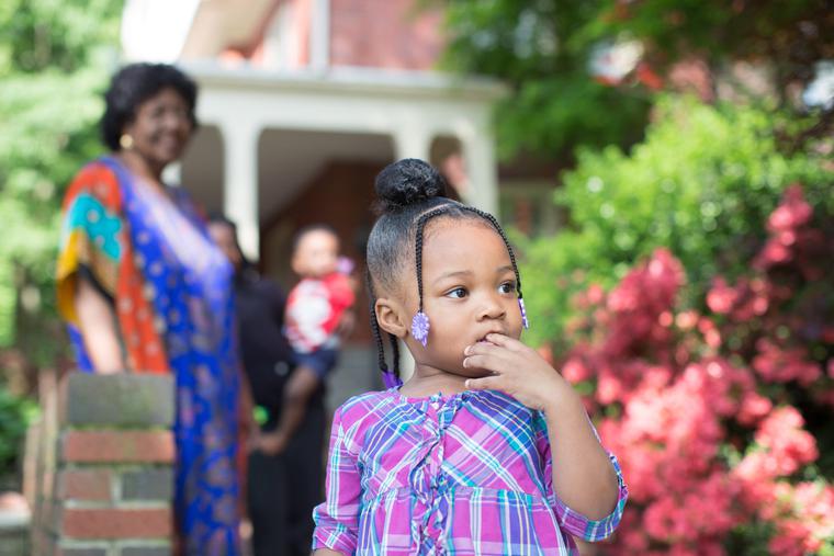 A young girl looks out as her foster mother, Sharonell Fulton, watches her from a distance in Philadelphia, Pa. A young girl looks out as her foster mother, Sharonell Fulton, watches her from a distance in Philadelphia, Pa.