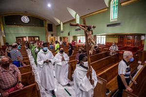 Church members pray for their neighbors during a Mass at St. Joseph Catholic Church on June 27 in Surfside, Florida. Parishioners are among the dead and missing.