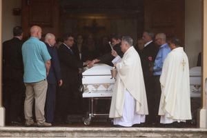 Father Juan Sosa blesses the caskets during the July 6 funeral in St. Joseph Catholic Church for Anaely Rodriguez, her husband, Marcus Guara, and their daughters, Lucia Guara and Emma Guara, after the family was killed in the partially collapsed 12-story Champlain Towers South condo in Miami Beach, Florida. Father Juan Sosa blesses the caskets during the July 6 funeral in St. Joseph Catholic Church for Anaely Rodriguez, her husband, Marcus Guara, and their daughters, Lucia Guara and Emma Guara, after the family was killed in the partially collapsed 12-story Champlain Towers South condo in Miami Beach, Florida.