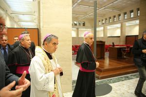 Then-Msgr. Angelo Becciu, shown above in white vestments attending the blessing and inauguration of the media center and pilgrimage information center for the Extraordinary Jubilee of Mercy on Dec. 1, 2015, is among the 10 people summoned to trial over the failed London property deal.
