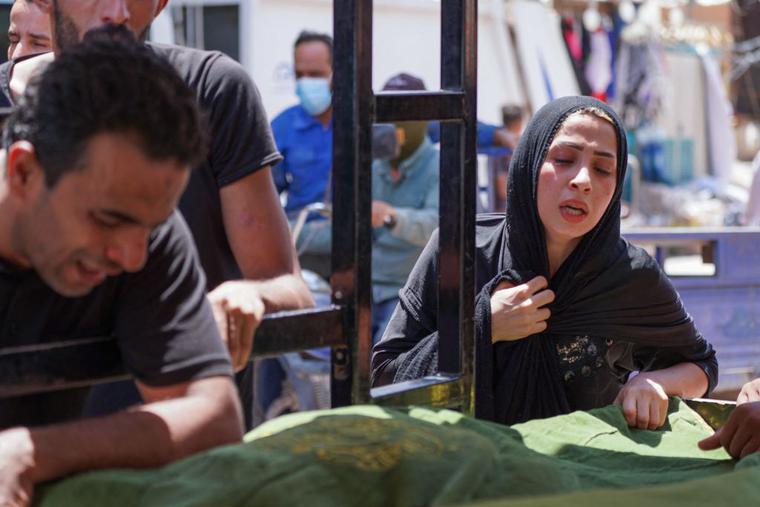 Iraqis mourn relatives who died in a massive fire which engulfed a coronavirus isolation ward of Al-Hussein hospital in the southern Iraqi city of Nasiriyah, during their funeral in the central city of Najaf, on July 13, 2021. Iraqis mourn relatives who died in a massive fire which engulfed a coronavirus isolation ward of Al-Hussein hospital in the southern Iraqi city of Nasiriyah, during their funeral in the central city of Najaf, on July 13, 2021.