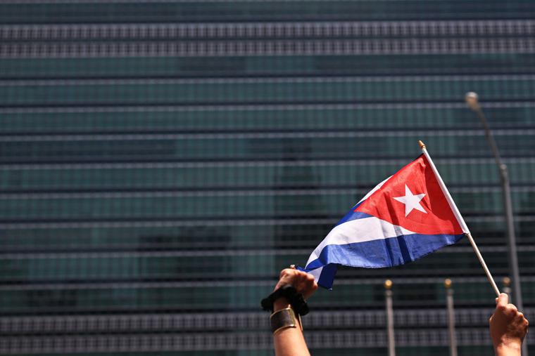 A person holds up a Cuban flag as people gather July 14 in front of the United Nations in New York City ; those gathered were calling for help for Cuban protesters. The island-nation protest has been the largest anti-government protest in decades. A person holds up a Cuban flag as people gather July 14 in front of the United Nations in New York City ; those gathered were calling for help for Cuban protesters. The island-nation protest has been the largest anti-government protest in decades.