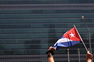A person holds up a Cuban flag as people gather July 14 in front of the United Nations in New York City ; those gathered were calling for help for Cuban protesters. The island-nation protest has been the largest anti-government protest in decades. A person holds up a Cuban flag as people gather July 14 in front of the United Nations in New York City ; those gathered were calling for help for Cuban protesters. The island-nation protest has been the largest anti-government protest in decades.