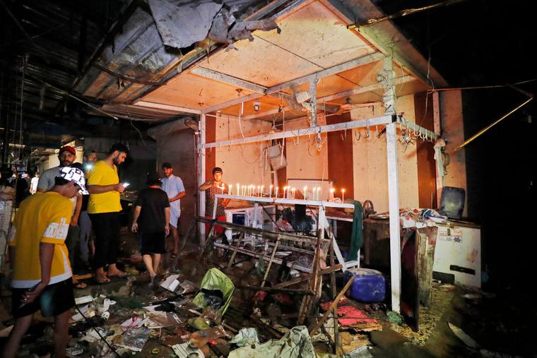 Iraqis light candles at the site of the explosion in a popular market in the mostly Shiite neighborhood of Sadr City on July 19. An explosion tore through the busy Baghdad market, killing at least 30 and wounding more than 50, in what Iraq says was a ‘terror attack’ by an apparent suicide bomber. Iraqis light candles at the site of the explosion in a popular market in the mostly Shiite neighborhood of Sadr City on July 19. An explosion tore through the busy Baghdad market, killing at least 30 and wounding more than 50, in what Iraq says was a ‘terror attack’ by an apparent suicide bomber.