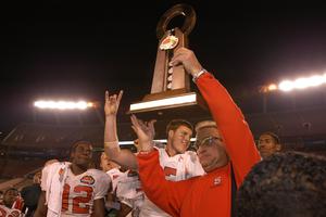 Coach Chuck Amato celebrates the Wolfpack's 56-26 win over Kansas in the 2003 Mazda Tangerine Bowl with WR Jerricho Cotchery and QB Philip Rivers. Coach Chuck Amato celebrates the Wolfpack's 56-26 win over Kansas in the 2003 Mazda Tangerine Bowl with WR Jerricho Cotchery and QB Philip Rivers.