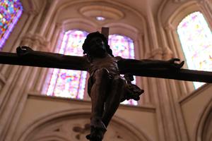 The crucifix is seen against a backdrop of stained glass in St. Ignatius Church in Paris. The crucifix is seen against a backdrop of stained glass in St. Ignatius Church in Paris.