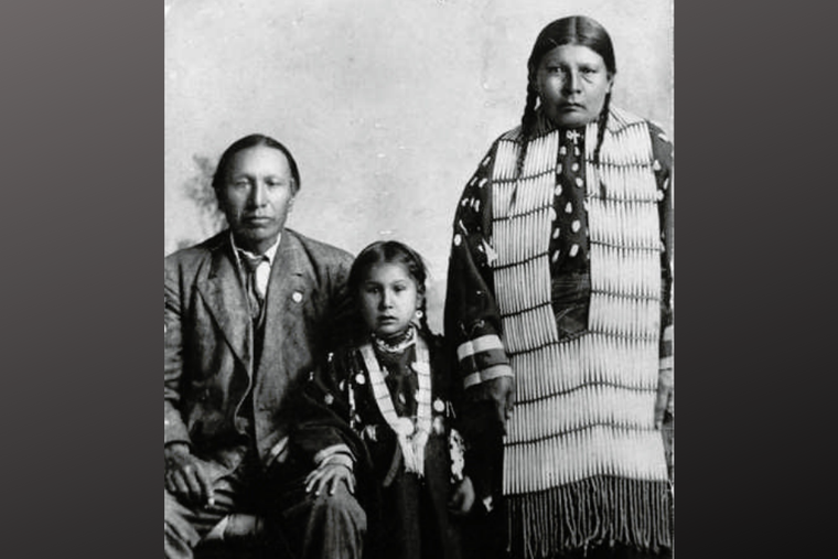 Servant of God Nicholas Black Elk, daughter Lucy Black Elk and wife Anna Brings White, photographed in their home in Manderson, South Dakota, ca 1910. Servant of God Nicholas Black Elk, daughter Lucy Black Elk and wife Anna Brings White, photographed in their home in Manderson, South Dakota, ca 1910.