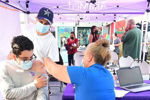 Christian Cruz, 20, receives his Pfizer Covid-19 vaccine from Registered Nurse Amy Berecz-Ortega from AltaMed Health Services in Los Angeles, California on August 17, 2021. Christian Cruz, 20, receives his Pfizer Covid-19 vaccine from Registered Nurse Amy Berecz-Ortega from AltaMed Health Services in Los Angeles, California on August 17, 2021.