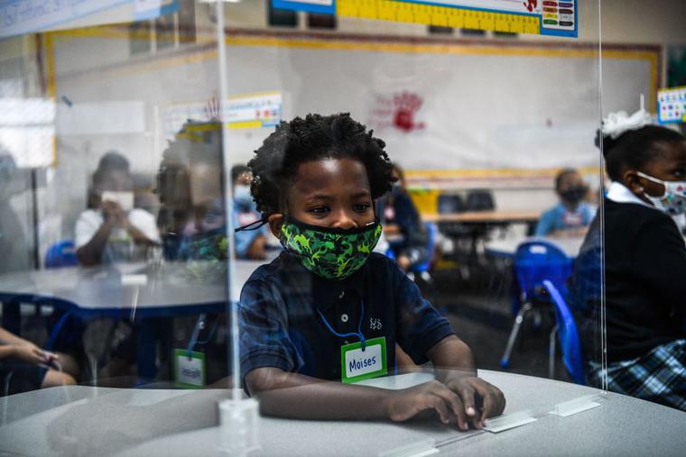 Student wear facemasks as they attend their first day in school after summer vacation at the St. Lawrence Catholic School in north of Miami, on August 18, 2021. Student wear facemasks as they attend their first day in school after summer vacation at the St. Lawrence Catholic School in north of Miami, on August 18, 2021.