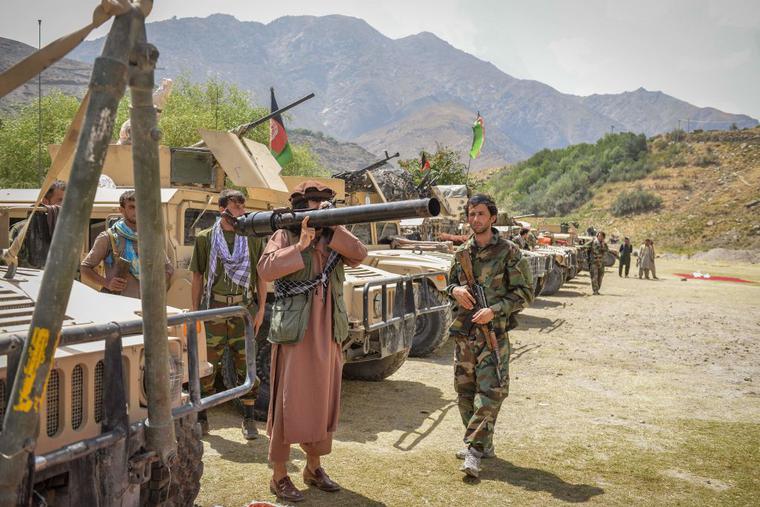Afghan armed men supporting the Afghan security forces against the Taliban stand with their weapons and Humvee vehicles at Parakh area in Bazarak, Panjshir province on August 19, 2021. Afghan armed men supporting the Afghan security forces against the Taliban stand with their weapons and Humvee vehicles at Parakh area in Bazarak, Panjshir province on August 19, 2021.