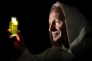 A Carthusian inspects a sample of chartreuse. A Carthusian inspects a sample of chartreuse.