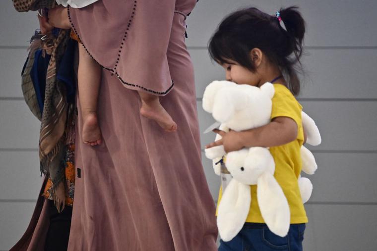 Afghan evacuees arrive at Incheon International Airport outside Seoul on August 26, 2021, following their departure from Kabul via Pakistan. Afghan evacuees arrive at Incheon International Airport outside Seoul on August 26, 2021, following their departure from Kabul via Pakistan.