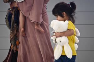 Afghan evacuees arrive at Incheon International Airport outside Seoul on August 26, 2021, following their departure from Kabul via Pakistan. Afghan evacuees arrive at Incheon International Airport outside Seoul on August 26, 2021, following their departure from Kabul via Pakistan.