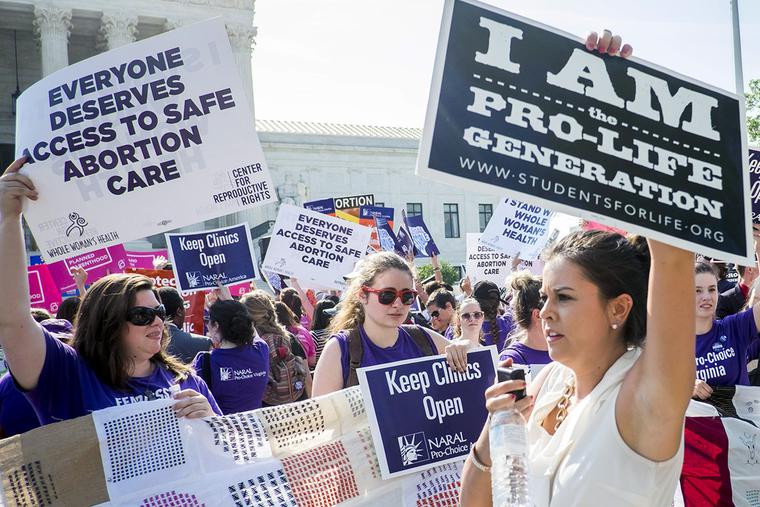 Pro-abortion and pro-life activists demonstrate on the steps of the United States Supreme Court on June 27, 2016, in Washington, DC. Pro-abortion and pro-life activists demonstrate on the steps of the United States Supreme Court on June 27, 2016, in Washington, DC.