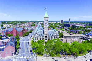 An aerial view of City Hall and the downtown district of Lowell, Massachusetts, is shown. One student at the University of Massachusetts at Lowell, Hunter Harris, and a student at the University of Massachusetts at Boston sued the state-college system when their appeal for a religious exemption to the COVID-19 vaccination was denied. An aerial view of City Hall and the downtown district of Lowell, Massachusetts, is shown. One student at the University of Massachusetts at Lowell, Hunter Harris, and a student at the University of Massachusetts at Boston sued the state-college system when their appeal for a religious exemption to the COVID-19 vaccination was denied.