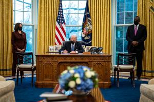 Flanked by Vice President Kamala Harris, l, and Secretary of Defense Lloyd Austin, r, U.S. President Joe Biden signs an executive order repealing the ban on transgender people serving openly in the military in the Oval Office of the White House on Jan. 25. Flanked by Vice President Kamala Harris, l, and Secretary of Defense Lloyd Austin, r, U.S. President Joe Biden signs an executive order repealing the ban on transgender people serving openly in the military in the Oval Office of the White House on Jan. 25.