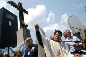 NEW YORK, UNITED STATES:  Father Brian Jordan presides over the final Sunday Mass at Ground Zero in New York, June 02, 2002. Several hundred relatives of those killed in the Sept. 11 attacks on the World Trade Center gathered for a day of interfaith services.