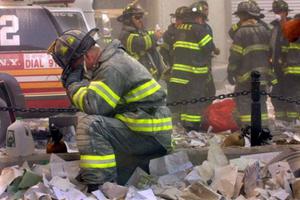 Firefighter Gerard McGibbon, of Engine 283 in Brownsville, Brooklyn, prays after the World Trade Center buildings collapsed on Sept. 11, 2001.