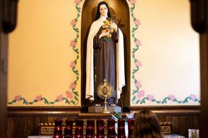 A young girl prays before a statue of St. Thérèse at the Basilica Parish of the Sacred Hearts of Jesus and Mary in Southampton, New York. A young girl prays before a statue of St. Thérèse at the Basilica Parish of the Sacred Hearts of Jesus and Mary in Southampton, New York.