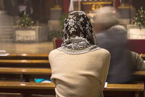 Photo illustration of a woman attending a Traditional Latin Mass. Photo illustration of a woman attending a Traditional Latin Mass.