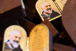 Diptychs of Padre Pio are displayed at a religious gift store at San Giovanni Rotondo in the Puglia region in southern Italy on April 23, 2008 on the eve of the public exhibition of the saint’s body. Diptychs of Padre Pio are displayed at a religious gift store at San Giovanni Rotondo in the Puglia region in southern Italy on April 23, 2008 on the eve of the public exhibition of the saint’s body.