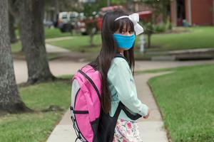 Photo illustration of a student mandated to wear a mask while in class. Photo illustration of a student mandated to wear a mask while in class.
