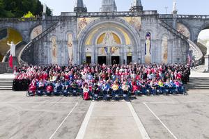 Malades and members of the Order of Malta pose for a picture in front of the Rosary Basilica. Malades and members of the Order of Malta pose for a picture in front of the Rosary Basilica.