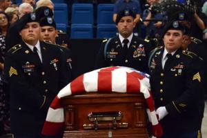 The casket containing the remains of Father Emil Kapaun is processed into Hartman Arena Sept. 29 for the Mass of Christian burial. The casket containing the remains of Father Emil Kapaun is processed into Hartman Arena Sept. 29 for the Mass of Christian burial.
