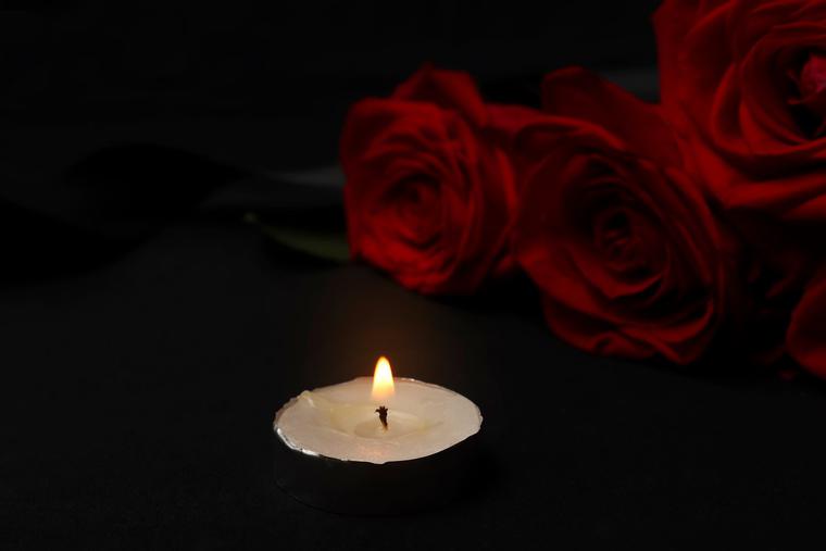 Photo illustration of a red rose and votive candle Photo illustration of a red rose and votive candle
