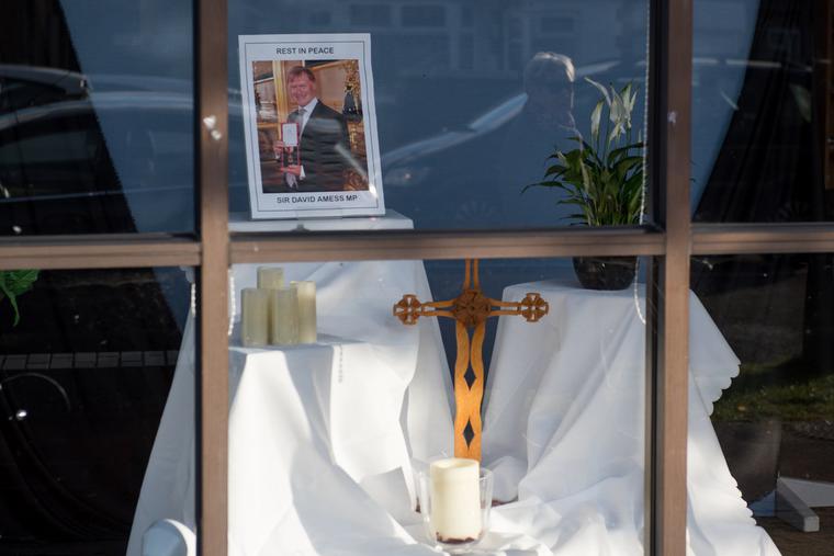 A memorial for Sir David Amess is seen set up in the window of the Belfairs Methodist Church on Oct. 21. Amess was stabbed to death on Oct. 15 during a parliamentary constituent event at the church. A memorial for Sir David Amess is seen set up in the window of the Belfairs Methodist Church on Oct. 21. Amess was stabbed to death on Oct. 15 during a parliamentary constituent event at the church.