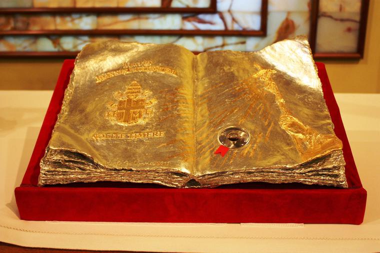 This golden book contains a first-class relic of Pope St. John Paul II This golden book contains a first-class relic of Pope St. John Paul II