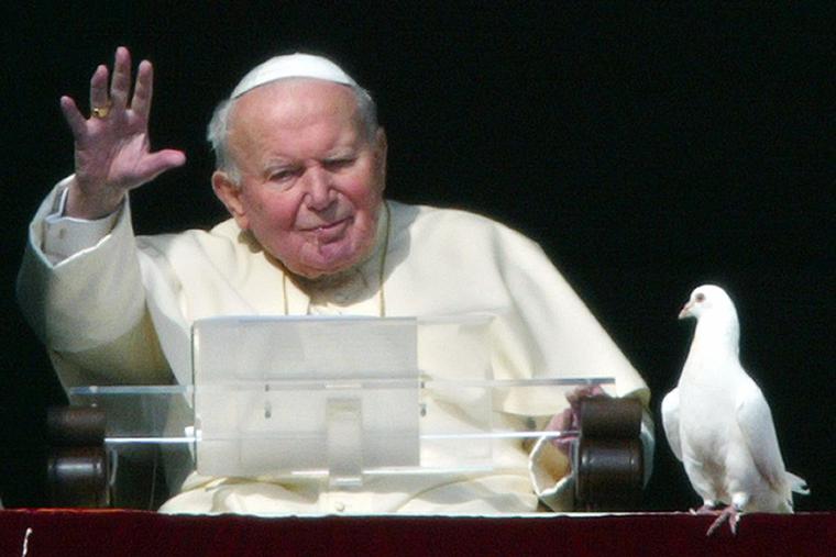 Pope John Paul II blesses the pilgrims gathered at St. Peter's square after he released two doves from the window of the papal apartments at the end of his weekly Angelus prayer, Jan. 25, 2004, at the Vatican. Pope John Paul II blesses the pilgrims gathered at St. Peter's square after he released two doves from the window of the papal apartments at the end of his weekly Angelus prayer, Jan. 25, 2004, at the Vatican.