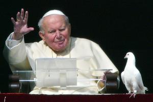 Pope John Paul II blesses the pilgrims gathered at St. Peter's square after he released two doves from the window of the papal apartments at the end of his weekly Angelus prayer, Jan. 25, 2004, at the Vatican. Pope John Paul II blesses the pilgrims gathered at St. Peter's square after he released two doves from the window of the papal apartments at the end of his weekly Angelus prayer, Jan. 25, 2004, at the Vatican.