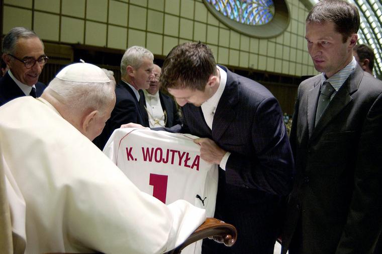 Unidentified players from the Polish national soccer team give Pope John Paul II a team shirt inscribed with his name at the Paul VI Audience Hall at the Vatican, Nov. 11, 2003. Unidentified players from the Polish national soccer team give Pope John Paul II a team shirt inscribed with his name at the Paul VI Audience Hall at the Vatican, Nov. 11, 2003.