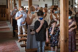 Families attend Mass amid the COVID pandemic. Families attend Mass amid the COVID pandemic.