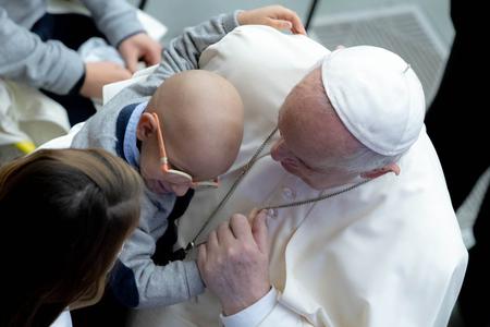 Pope Francis hugs a young boy during his general audience address in the Paul VI Hall of the Vatican Oct. 27, 2021 Pope Francis hugs a young boy during his general audience address in the Paul VI Hall of the Vatican Oct. 27, 2021