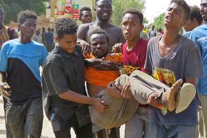 Sudanese carry a man injured during clashes as part of protests against a military coup that overthrew the transition to civilian rule, on October 25, 2021 in the capital Khartoum. Sudanese carry a man injured during clashes as part of protests against a military coup that overthrew the transition to civilian rule, on October 25, 2021 in the capital Khartoum.