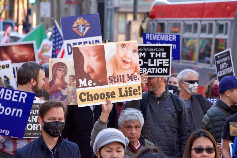 Demonstrators hold pro-life signs on the streets of San Francisco. Demonstrators hold pro-life signs on the streets of San Francisco.